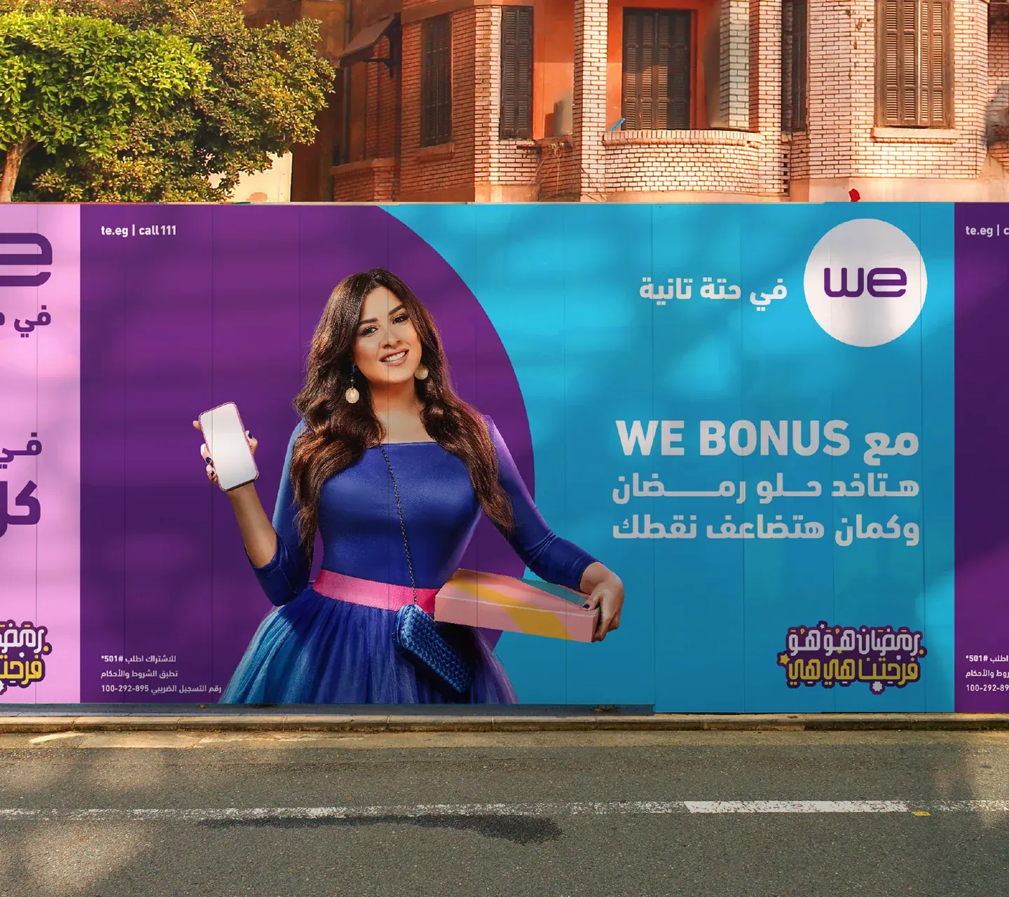 WE Bonus outdoor campaign mockup with a woman, phone and purple and cyan panels